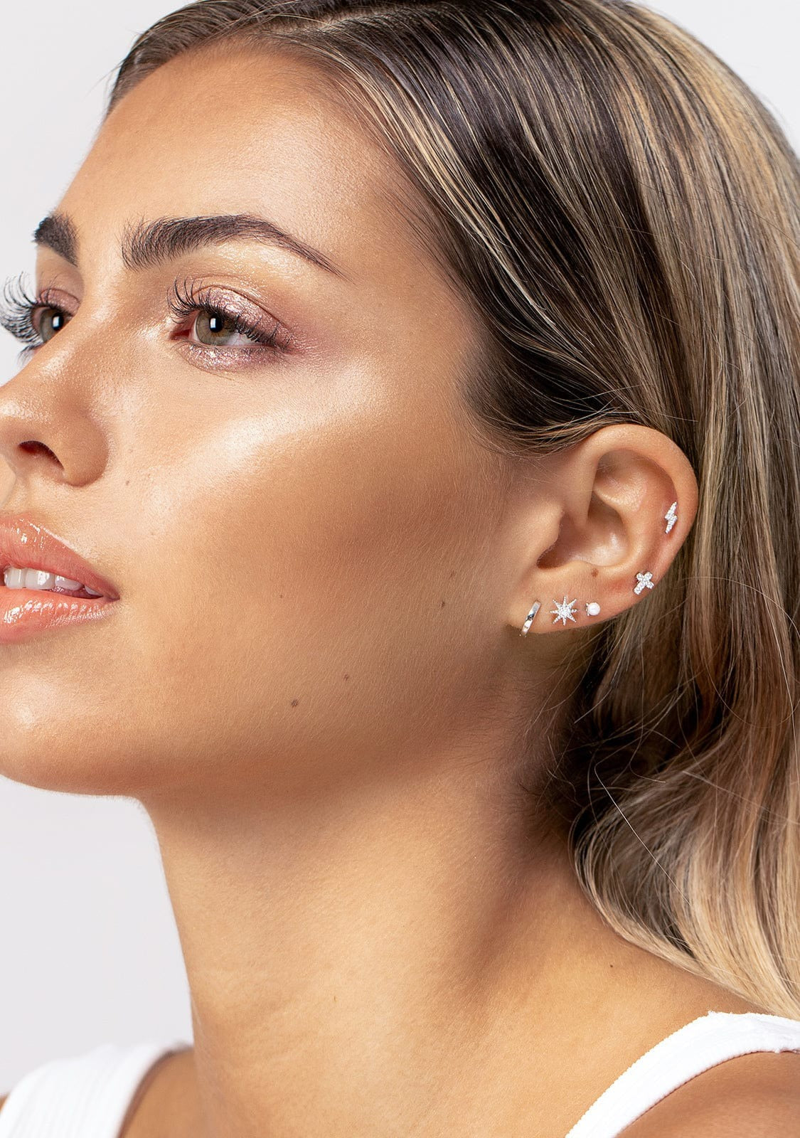 Woman posing with ear piercing as focal point
