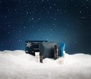 Elemis skincare products on a snowy landscape with a dark blue sky.