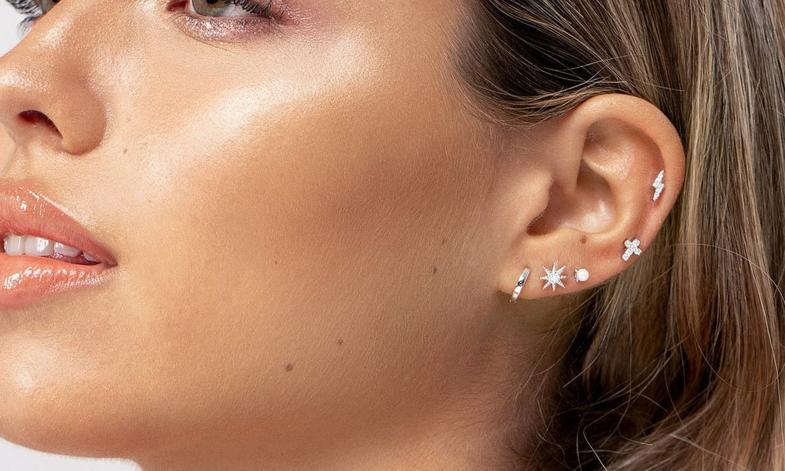 Woman posing with ear piercing as focal point