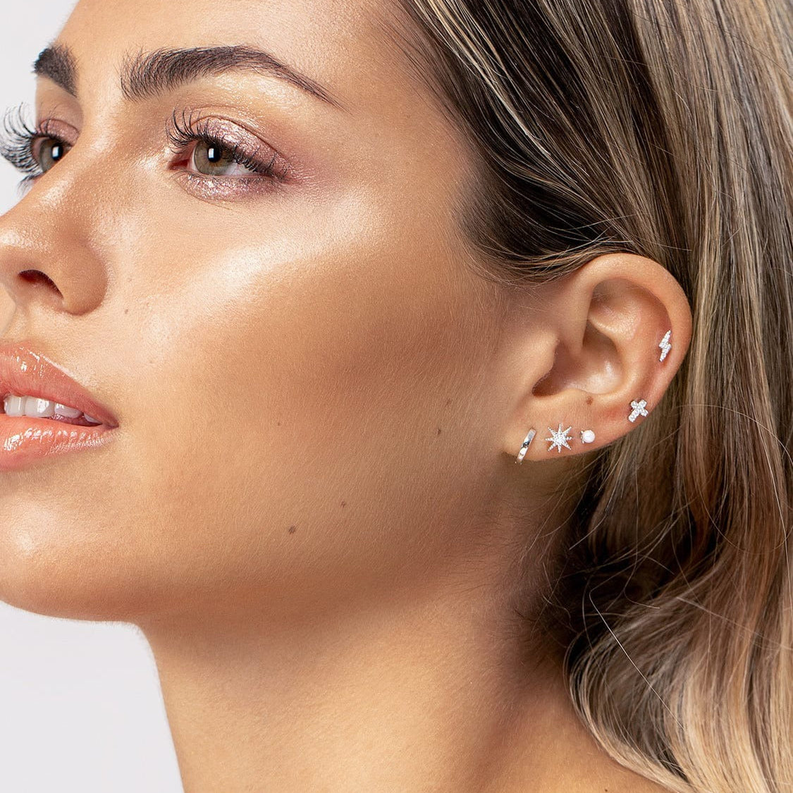 Woman posing with ear piercing as focal point
