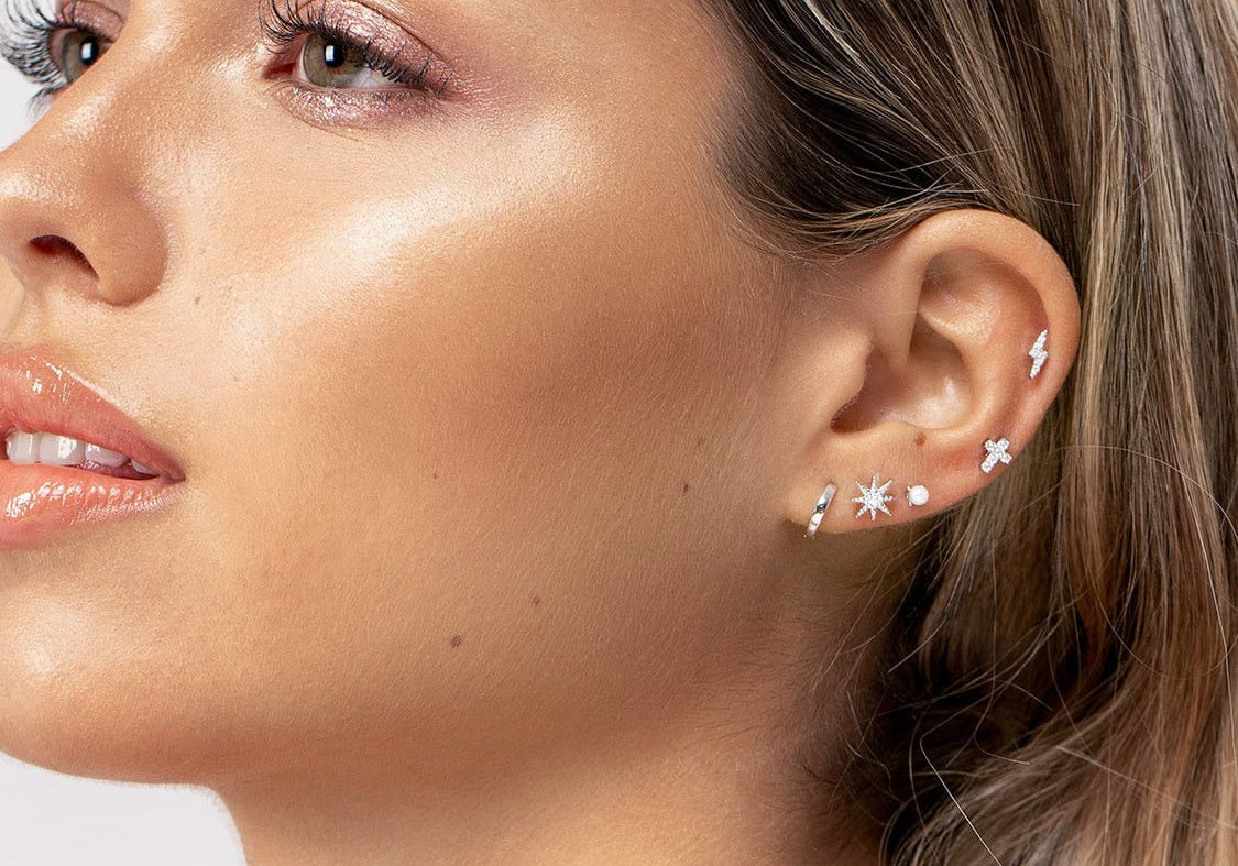 Woman posing with ear piercing as focal point