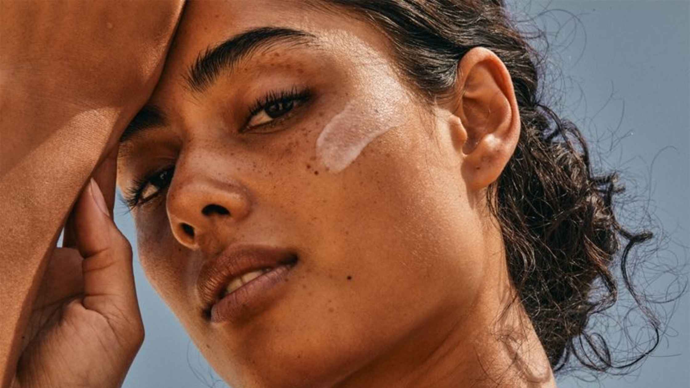 a woman with spf on her cheek