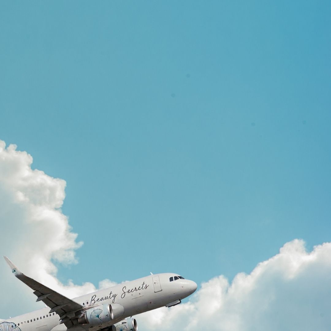 Airplane flying in the sky with clouds below