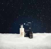 Elemis skincare products on a snowy landscape with a dark starry sky.