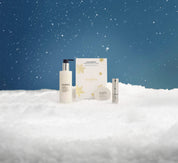 Elemis skincare products on a snowy landscape with a blue sky.