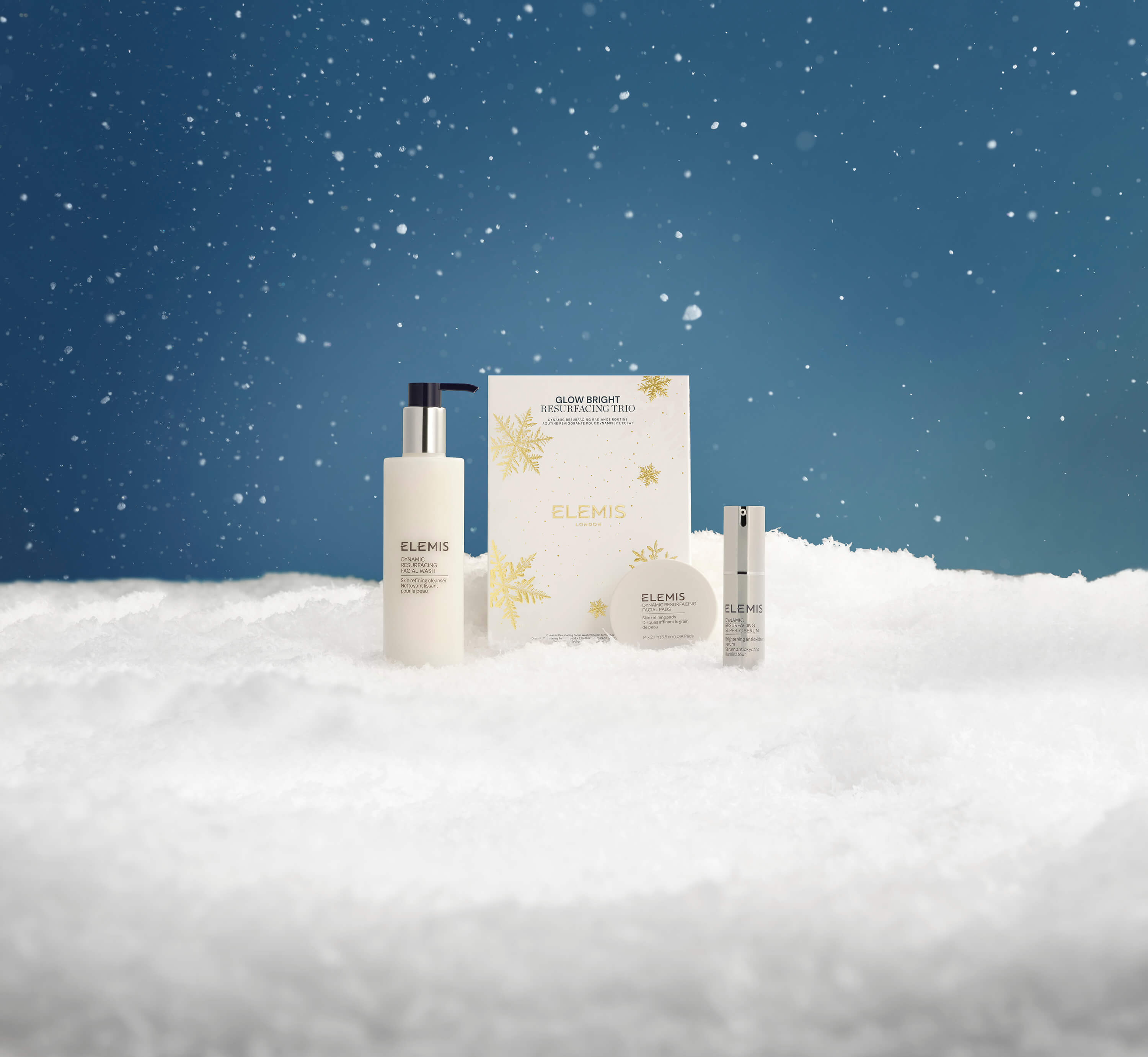 Elemis skincare products on a snowy landscape with a blue sky.