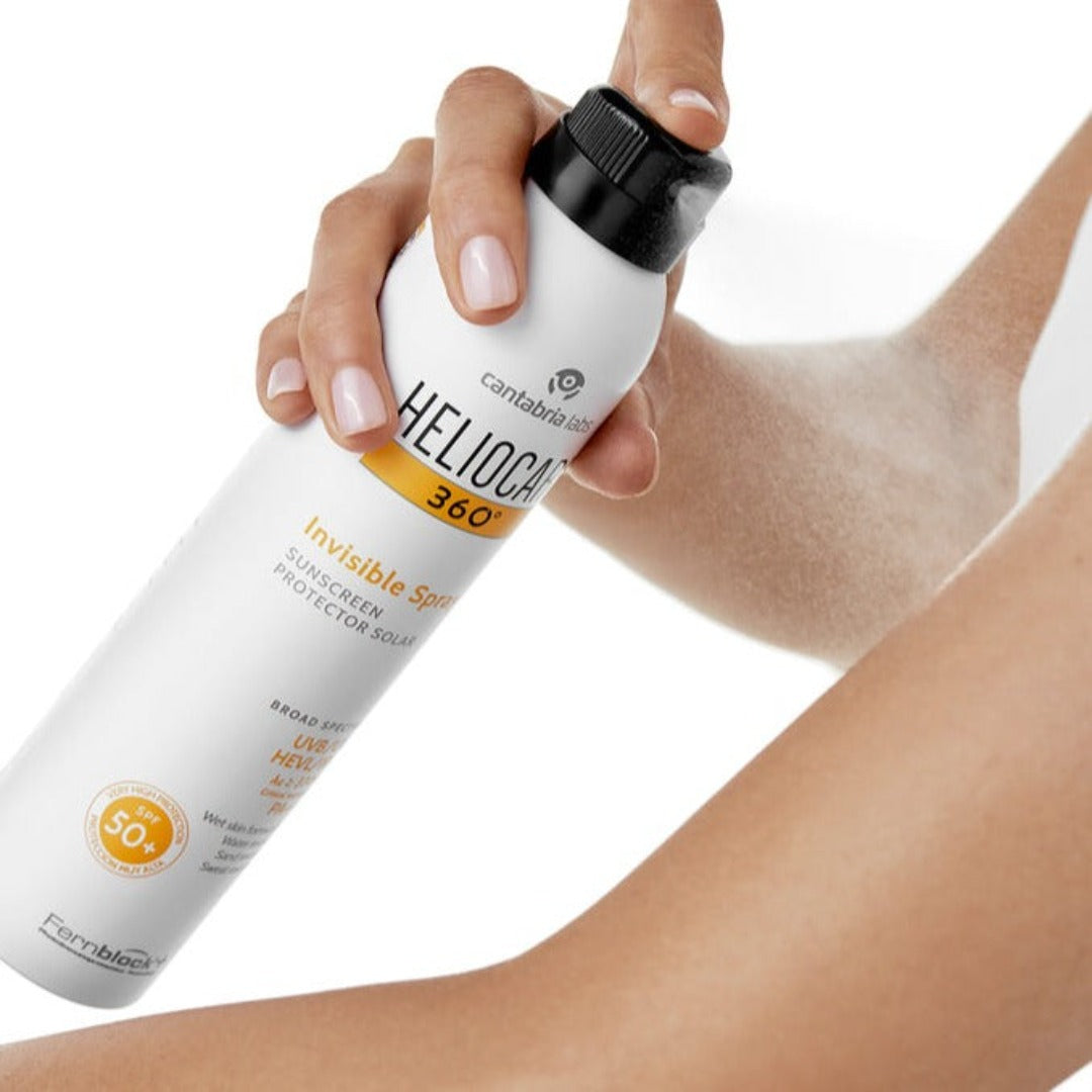Heliocare 360° Invisible Spray SPF 50+ spraying on arm. 