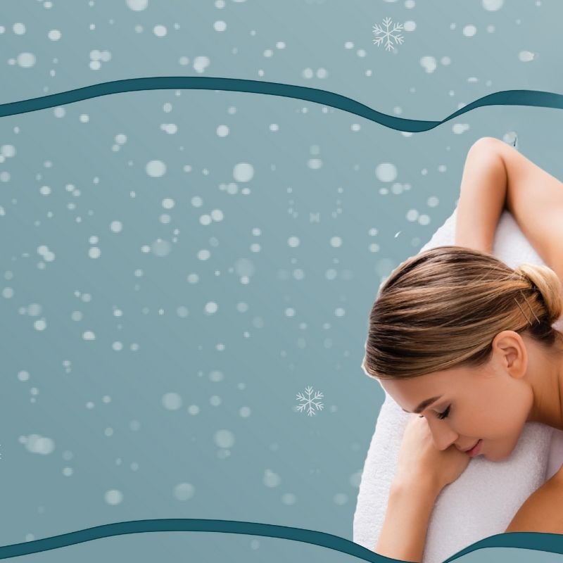 Woman wrapped in a towel against a snowy background