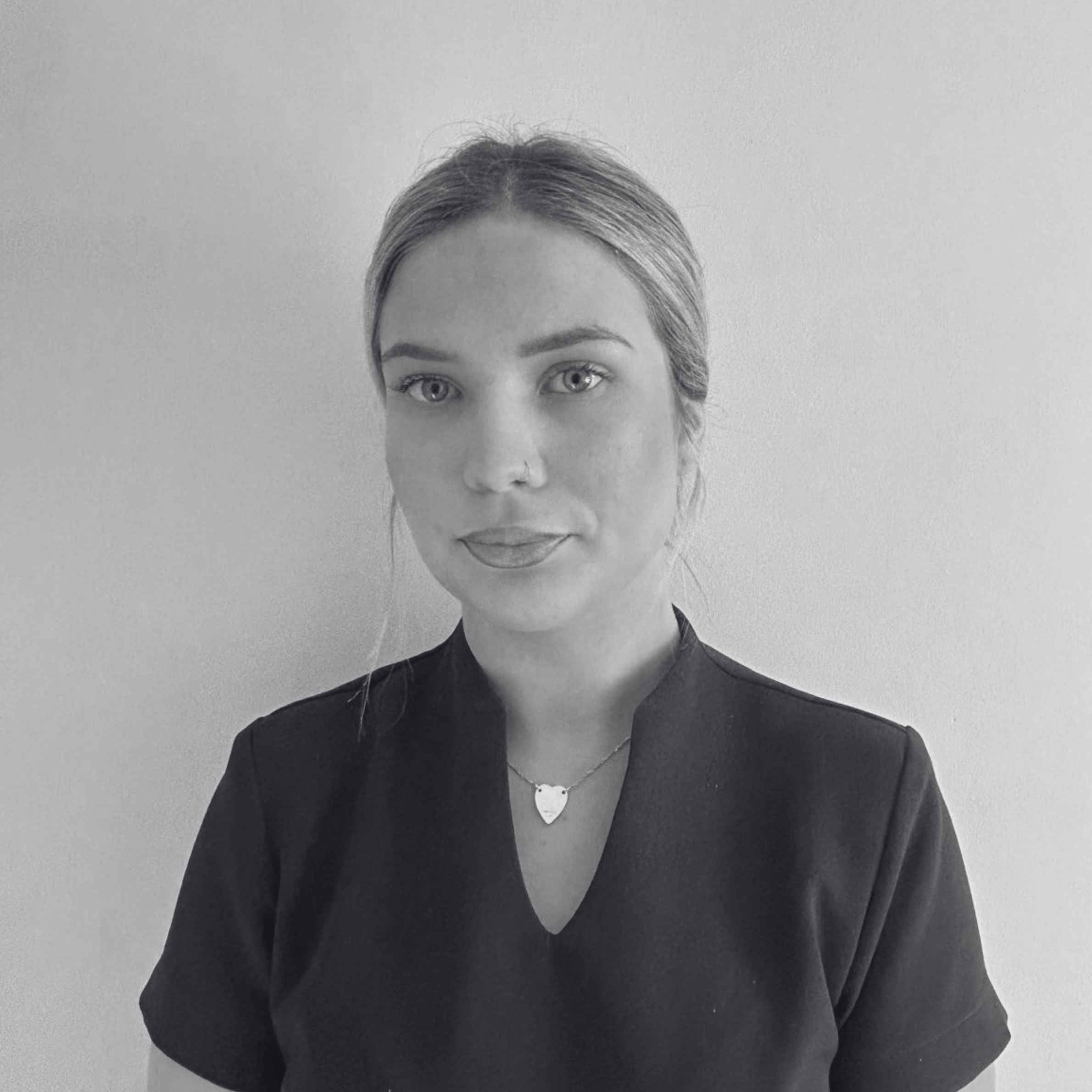 Black and white portrait of a woman with a plain background