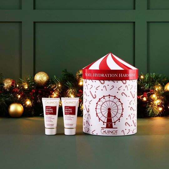 Guinot skincare products with a decorative box against a festive background
