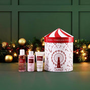 Guinot skincare products with a festive box against a green wall with decorations