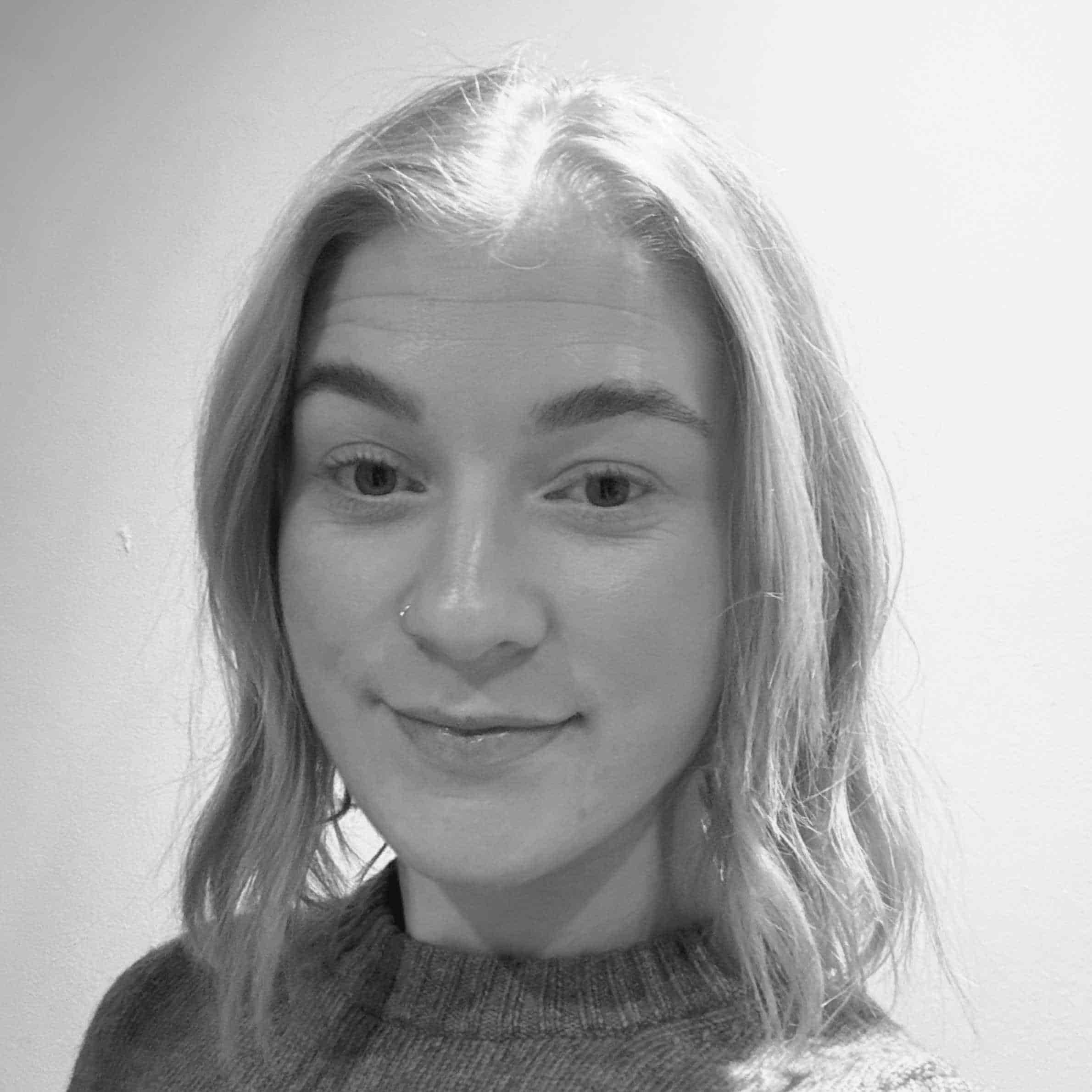 Black and white photo of a person with light hair and a neutral expression.