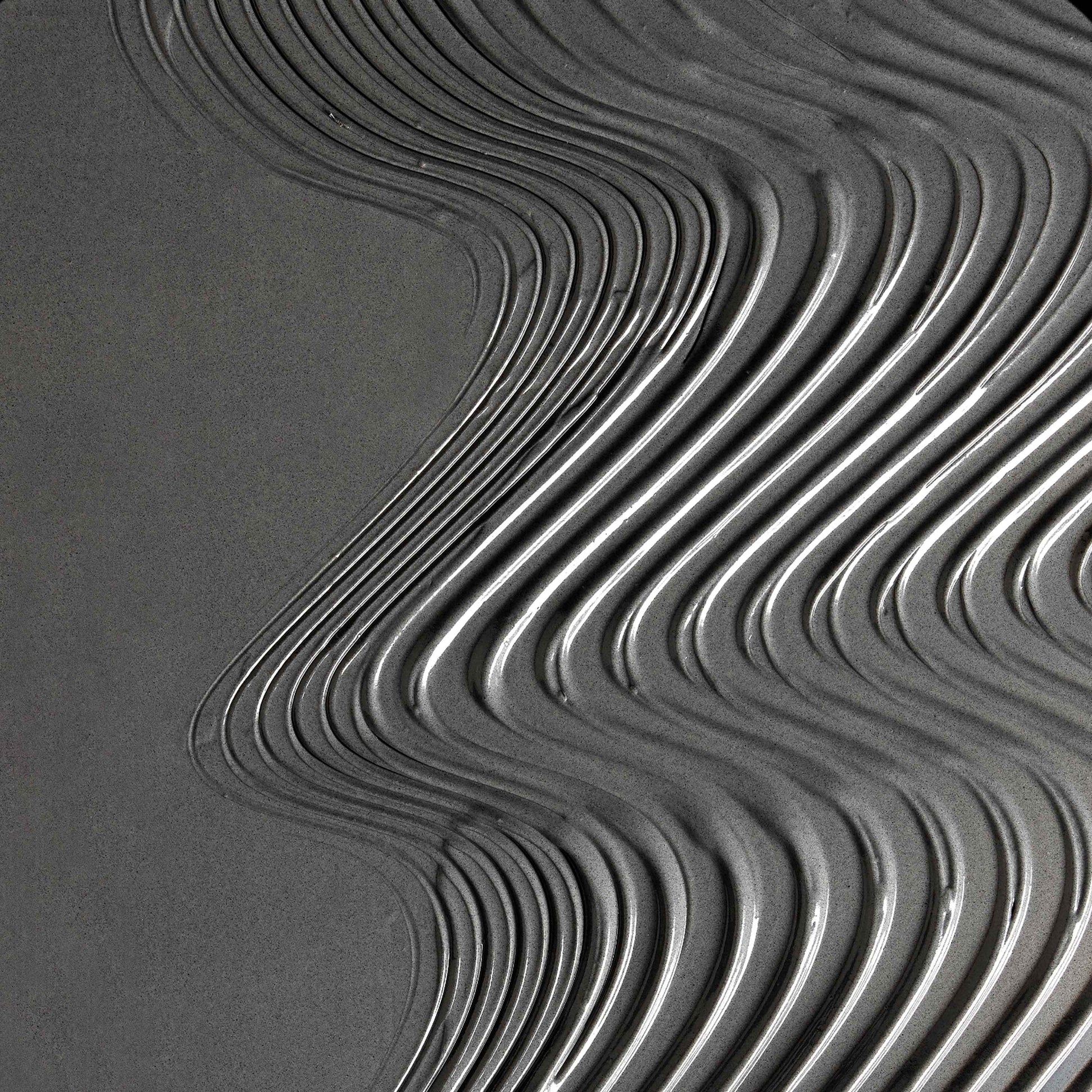 Close-up of wavy line pattern on a textured surface