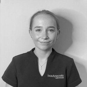 A black and white image of a Beauty Secrets employee